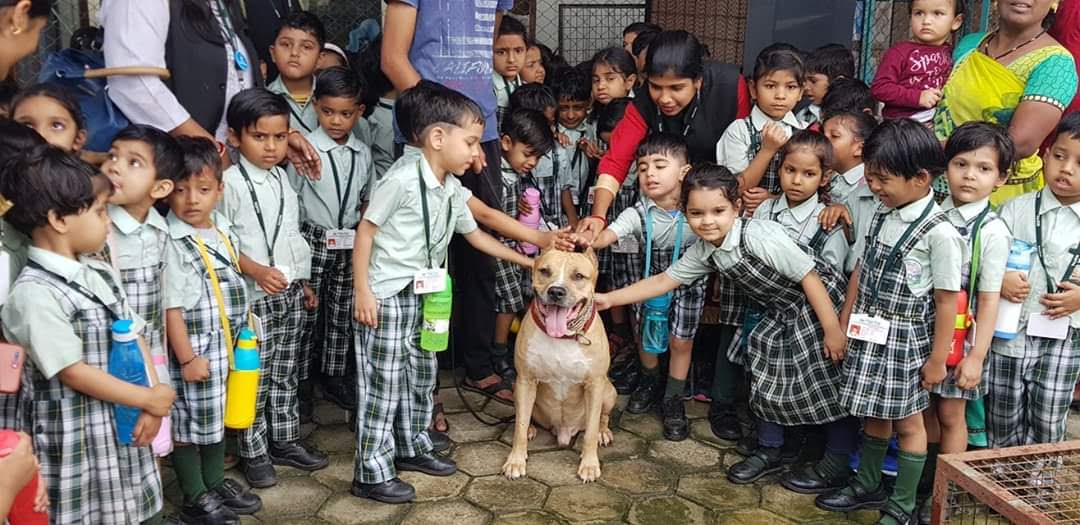 Davo surrounded by school children